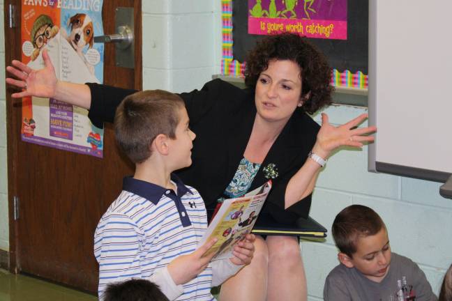 Commissioner of education visits Goshen Intermediate English Language Arts Consultant Elizabeth Kimiecik talks with Connor Gerlach about an article he read in Time Magazine for Kids.