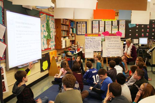Commissioner of education visits Goshen Intermediate Fifth-grade teacher Elizabeth Jung leads a lesson plan about inferences with her students.