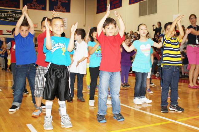 Smiles, giggles at Kindergarten Festival Sam Salte, Tyler Brosnan, Nathan Hulse, Fidelia Popik and Ashank Khound clap during the Cha Cha Slide.