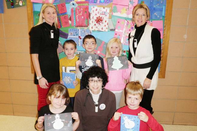 Hey soldier, happy holidays! Back row (from left): first-grade teacher Kerry Larney, Luke Vaccaro, Jaiden Chan, Abigail Hoffmain, and first-grade teacher Jean Schaefer. Front row: Allison O’Donnell, special education teacher Rita Laskin, and Logan Gilbert.