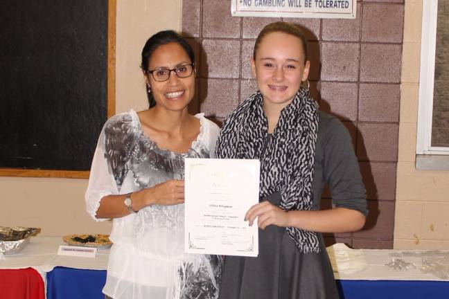 High school students honored as 'Goshen Greats' Oliva Klugman with foreign language teacher Marisol Paneto