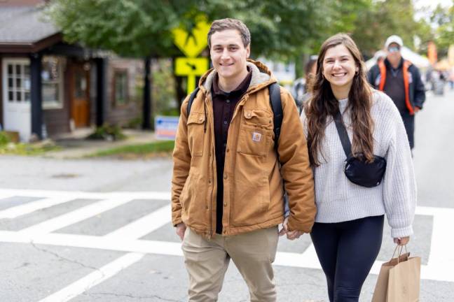 Astoria, NY couple Megan Aronica and Mike Musilli walk through the Sugar Loaf Fall Festival.