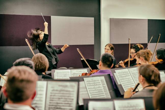 RAising the baton Elle Sunmin Lee, a New York City-based pianist and conductor, conducting the first movement of Tchaikovsky's Symphony No. 5 during last month's International Women's Conducting Workshop at the National Opera Center. Photo: Douglas Bain
