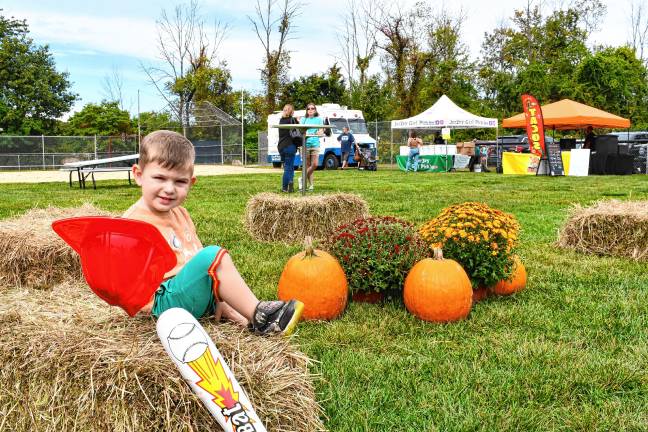 Fall festivals and Halloween happenings Cameron Riccardi of Stanhope plays among the pumpkins at the Stanhope Fall Festival on Saturday, Sept. 27. (Photo by Maria Kovic)