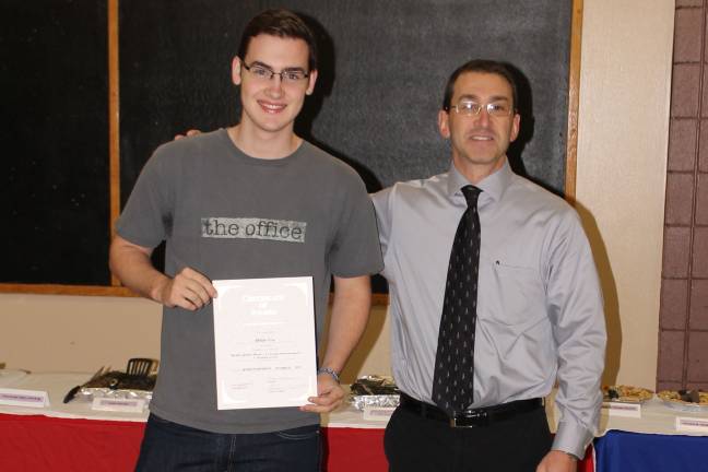 High school students honored as 'Goshen Greats' Ethan Tew with social studies teacher Michael Isseks