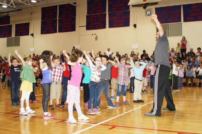 Smiles, giggles at Kindergarten Festival Physical Education Teachers John Mardyniak leads students during “Wipe Out.”