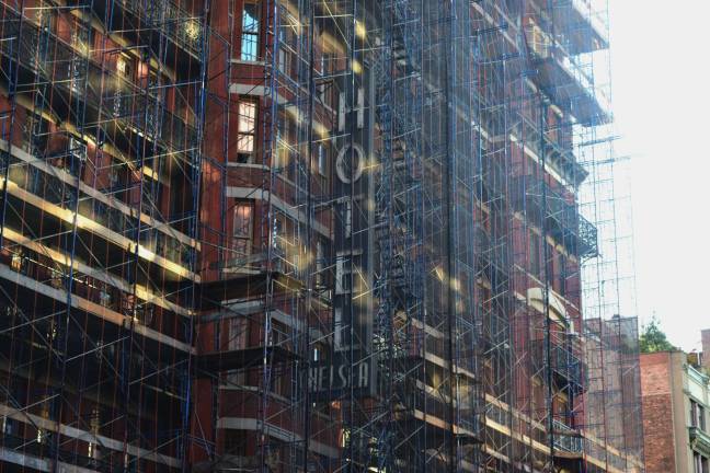 Remembering 'chelsea girls' Behind the scaffolding, the old sign for the Hotel Chelsea on West 23rd Street is still visible. Photo: Liz Hardaway