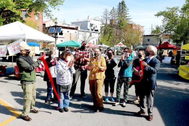 On Sunday, May 9, public officials and chamber representatives joined officers and vendors of the Warwick Farmers Market. to celebrate the opening for the season with a ribbon-cutting ceremony. From left, Town of Warwick Supervisor Michael Sweeton, Farmers Market Steering Committee Treasurer Linda Moser, Secretary Annette Sanchez, Co-Chair Will Ashby, Chairperson Cheryl Rogowski, Market Manager Kristen Menge, Warwick Valley Chamber of Commerce Executive Board President Elizabeth Cassidy, Merchant Guild President Corrine Cassidy and Mayor Michael Newhard. Photo by Roger Gavan.