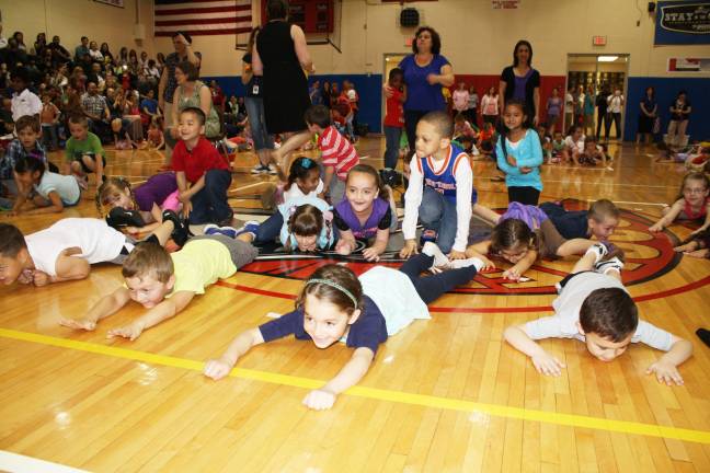 Smiles, giggles at Kindergarten Festival Ben Bockman, Mary Ann Mitchell and Sean Thomas get low!