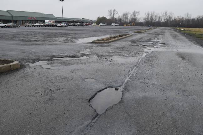Pothole Watch: Week 7 The rest of the Goshen Plaza parking lot remains riddled with potholes and crumbling pavement.