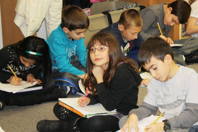 Commissioner of education visits Goshen Intermediate Third graders write down their answers during a lesson. Front, from left: Ysabela Paneto and Andrew Rampulla. Back: Nowall Khan, Anthony Mitchell, Daniel Serkes and Gabriel Brugelis.