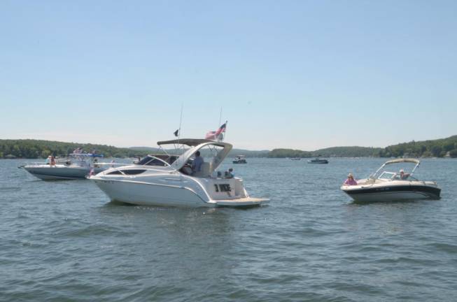 Boats gathered on Greenwood Lake near Donna Breur ‘s boathouse to be blessed by Rev. Dr. Ronnie T. Stout-Kopp.