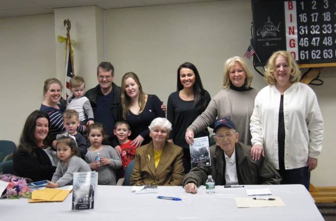 Photos by Ginny Privitar Local author Dominic Kelly (seated at far right), with wife Mary next to him, surrounded by their family.