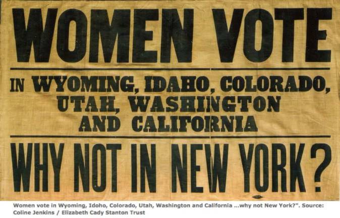 Suffragettes moving into Erie Station Suffragette placard asks, "WHY NOT IN NEW YORK?" Credit: Coline Jenkins / Elizabeth Cady Stanton Trust