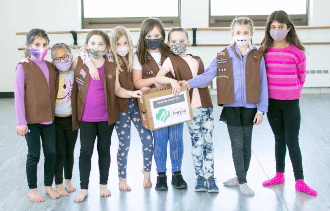 Members of Goshen Brownie Troop 146 collecting crayons for the Crayon initiative, a nationwide program that collects donated crayons, then melts them down to repurpose for art programs at children’s hospitals while reducing way sludge that clogs landfills. Photos provided by Kelly Williams.