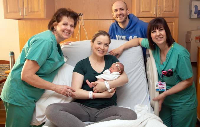 New family joined by nurses from the Kennedy Birthing Center at St. Anthony Community Hospital.