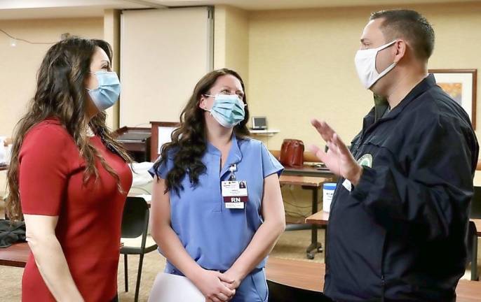 Orange County Executive Steven M. Neuhaus talks to (from left to right) ICU Registered Nurses Melanie Pinto and Sarah Stewart at Garnet Health Medical Center in Middletown on Wednesday, Dec. 16. Pinto, a COVID-19 survivor, was the first to get vaccinated at Garnet. Provided photo.