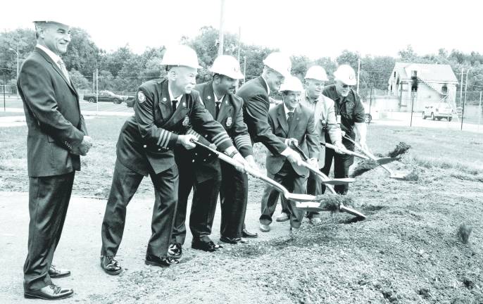 County breaks ground on new fire training building Photo by Ed Bailey Orange County broke ground last week on a new Fire Training Center burn building at the Countyís Fire Training Center in New Hampton. Pictured are: Emergency Services Commissioner Walter Koury, Fire Training Center Manager Jim McCann, Deputy Commissioner for Fire Services Vini Tankasali, Public Works Commissioner Charles Lee, Orange County Executive Edward A. Diana, Legislative Chairman Michael Pillmeier and Fire Advisory Board Chairman Lee Gerow. The current burn building can be seen in the background on the right.