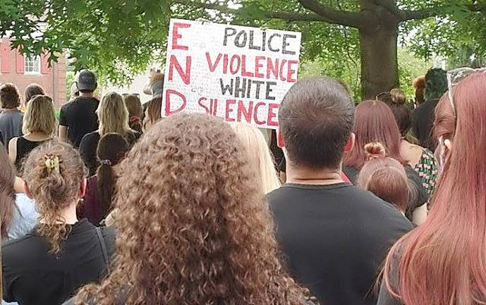 A portion of the more than 400 people who attended the protest are listening attentively to the words of the speakers during the June 5 protest at Church Park in Goshen. Photo by Geri Corey.