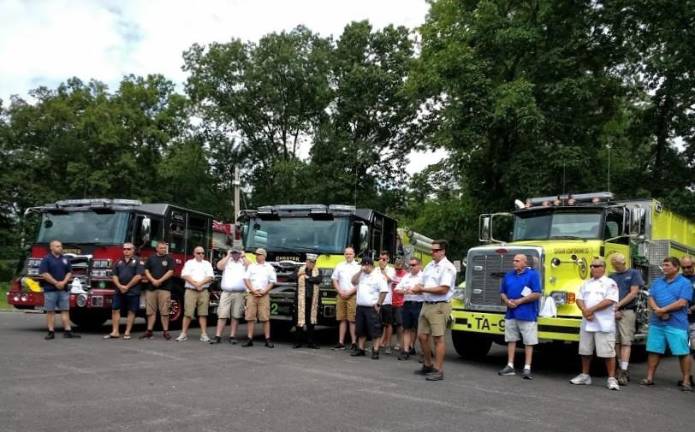 Chester Fire Department makes a splash with its new fleet Chief Pat McKevitt (sixth from right) and fellow firefighters at the wet-down.