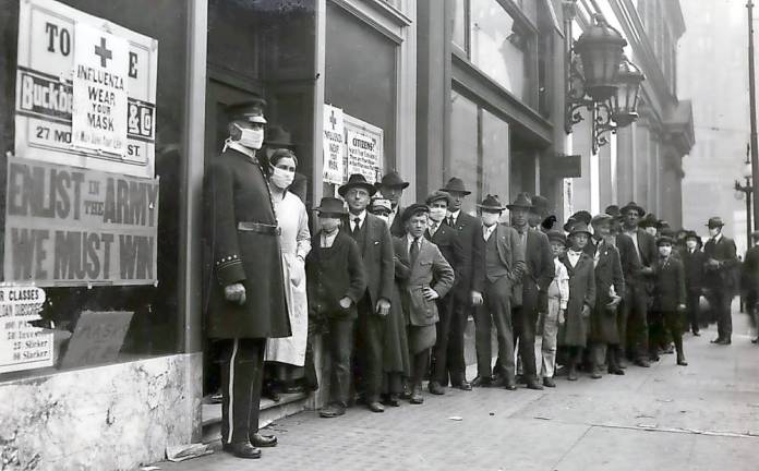 Then and now People wait in line to get flu masks to avoid the spread of Spanish influenza on Montgomery Street in San Francisco in October 1918.