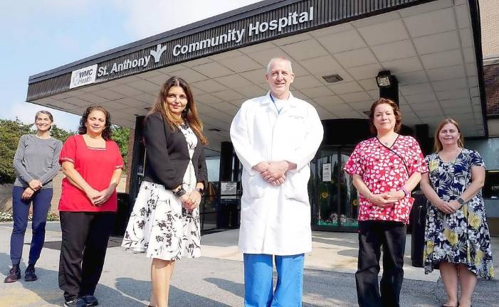 Bruce Fischer, DPM, FACFAS, Director of the Diabetic Foot Care Program, St. Anthony Community Hospital, and Anita Volpe, DNP, RN, VP/Hospital Administrator, St. Anthony Community Hospital, join members of the new team as they welcome patients. Photo provided by St. Anthony Community Hospital.