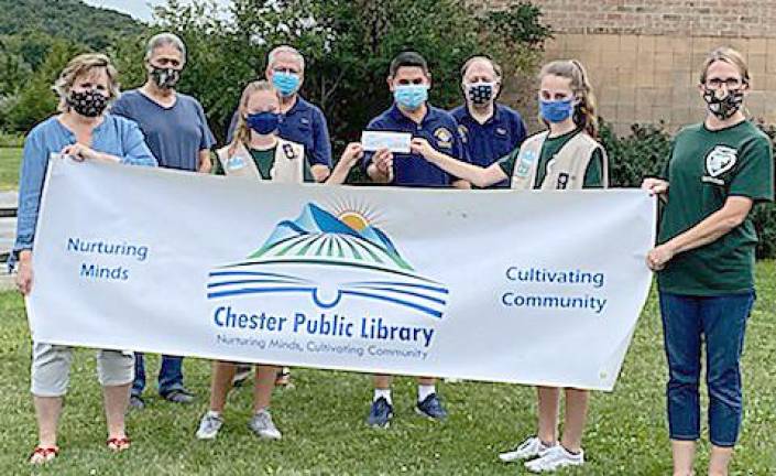 Orlando Perez presented a $400 check from the Chester Knights of Columbus to Girl Scout Abby Ferraro and Girl Scout 387 Troop Leader Carlie Cambria to assist in their Silver Award project of creating a community garden at the Chester Library. Pictured are: Joni Armstrong, Chester Public Library's children's librarian; Knights of Columbus members Ron Nelson,Dan Serritello, Orlando Perez and Kent Fletcher and Girl Scout Abby Ferraro and Troop Leader Kerry Cambria. Photo provided by Kerry Cambria.