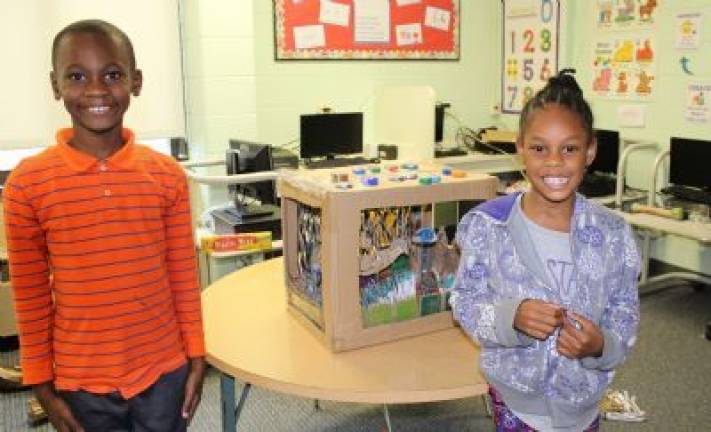 Cardboard challenge in Chester Stefan Simeon and Makayla show off their fish tank creation.