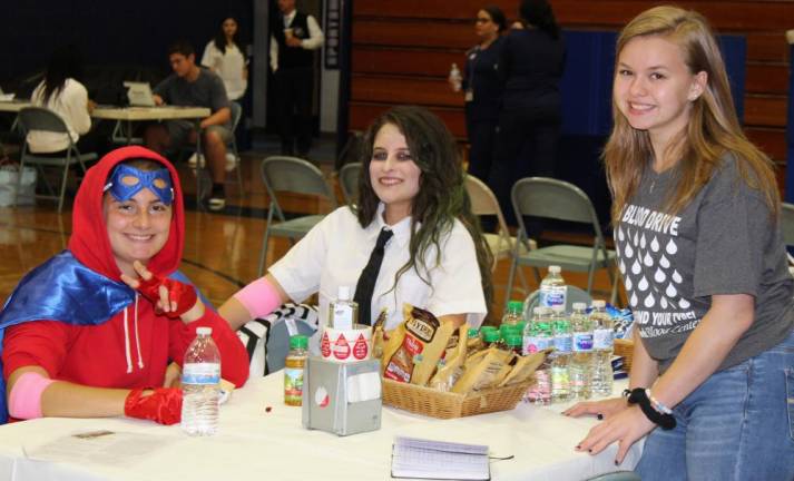 Burke Catholic junior Adriana Pratti, Burke Catholic senior Tiffany Ramos, and student co-captain Elizabeth Magnussen