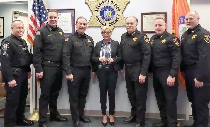 Deputy from the Dominican Republic to be keynote speaker at naturalization ceremony From left: DSPBA President Jeremy Yela, Chief Dennis Barry, Undersheriff Ken Jones, Deputy Carolina Manon, Sheriff Carl E. DuBois, Assistant Undersheriff Tony Weed, and Captain Paul Arteta