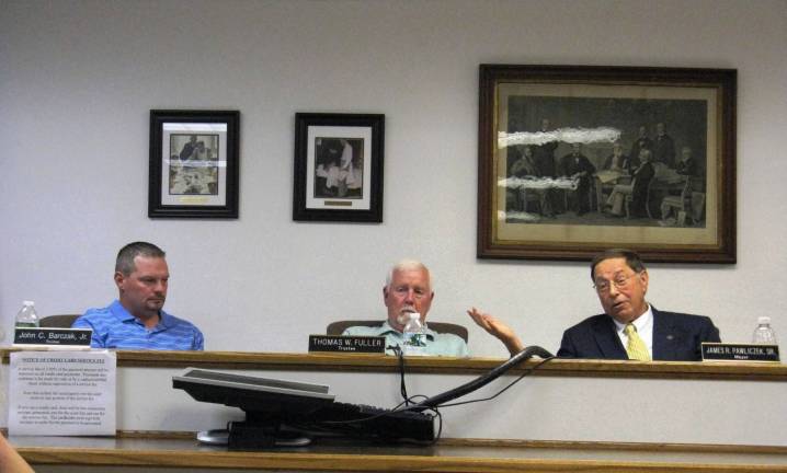 From left: Trustees John Barczak and Thomas Fuller and Mayor Jim Pawliczek at the Aug. 10 village board meeting (Photo by Ginny Privitar)