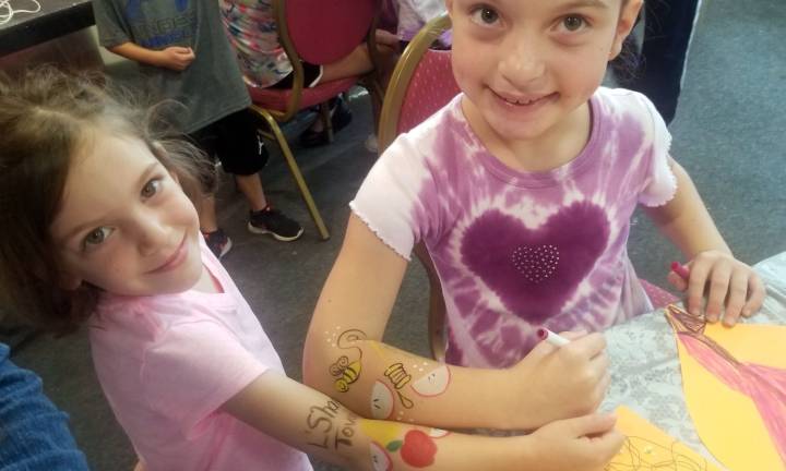 All are welcome at High Holiday Services and children’s programs at Chabad Chabad Hebrew School students Heather Sentell and Ruby Eberly, both of Monroe, show that they are “armed” with the New Year spirit. Kimberly Gemmati of Monroe was the creative artist behind the Rosh Hashanah arm art.