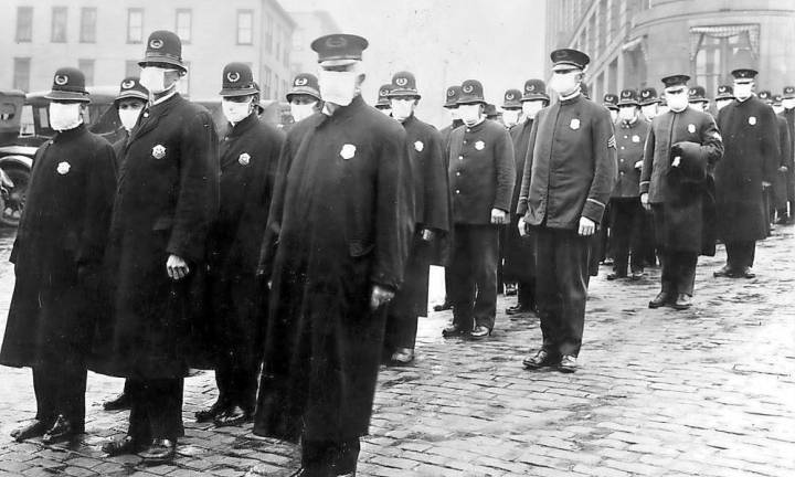 Then and now Policemen in Seattle wearing masks made by the Red Cross, during the influenza epidemic. December 1918.
