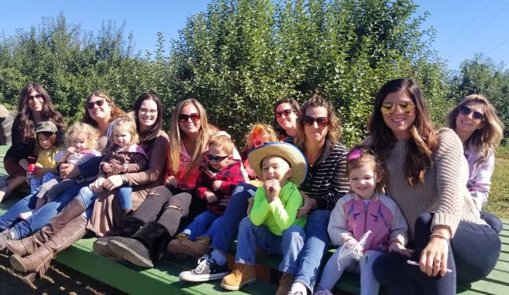 All are welcome at High Holiday Services and children’s programs at Chabad It’s not too early to learn. Toddlers at Chabad’s Ima & Me program, led by Chana Burston, learn about Rosh Hashanah by picking their own apples at a local farm.