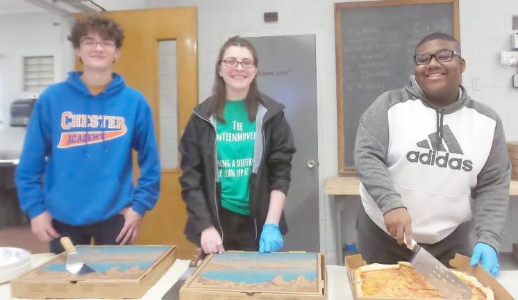 Green Teens serving pizza (from left): Sameer El-Rifai, Laura Edwards and Jonathan Walters-Suber