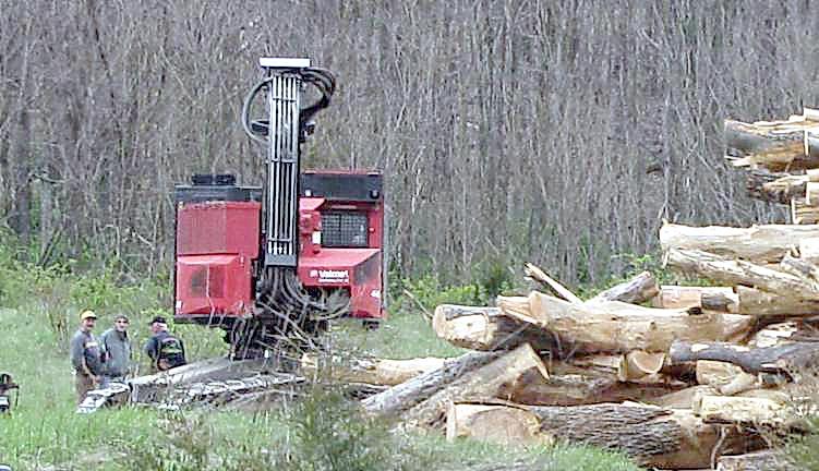 Steve Sherman (center) with logging contractors in spring 2012, when he attempted to recoup his losses by clear-cutting his acres and selling off the timber.