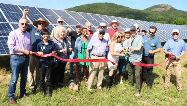 On Wednesday, June 26, Town of Warwick Supervisor Michael Sweeton (far right) and members of the Warwick Valley Chamber of Commerce climbed to the top of a hill overlooking Sugar Loaf Mountain to join members of the Orange County Citizens Foundation and representatives of SunCommon to celebrate the occasion with a ribbon cutting.