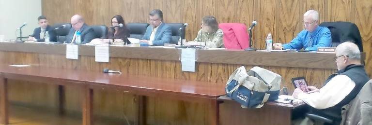 The new Chester Town Board (from left): Anthony Perez, Bob Courtenay, Clerk Linda Zappala, Supervisor Bob Valentine, Deputy Superintendent Cindy Smith, and Tom Becker, with engineer Al Fusco, seated.