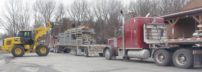 It took two rigs to bring the steel needed to rebuild Chester's highway building.
