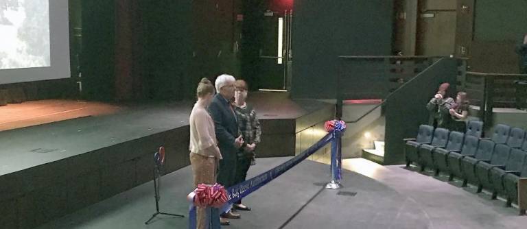 Roy Reese, flanked by GHS Vocal teacher Kristen Scully, left, and Molly Lloyd, Director of the spring musicals, right, as they prepare to be raised to stage level for the formal presentation.