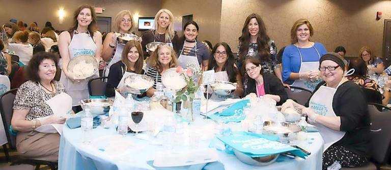 Chana Burston, center, is pictured at last year’s Mega Challah bake with local women from throughout Orange County. This year's Mega Bake is Nov. 3.