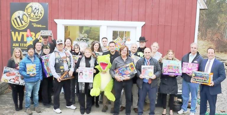 This photo is last year’s Toys for Military Tots Drive with everyone who contributed. It took place pre-pandemic so no one was required to wear masks or keep social distancing. File photo by Roger Gavan.