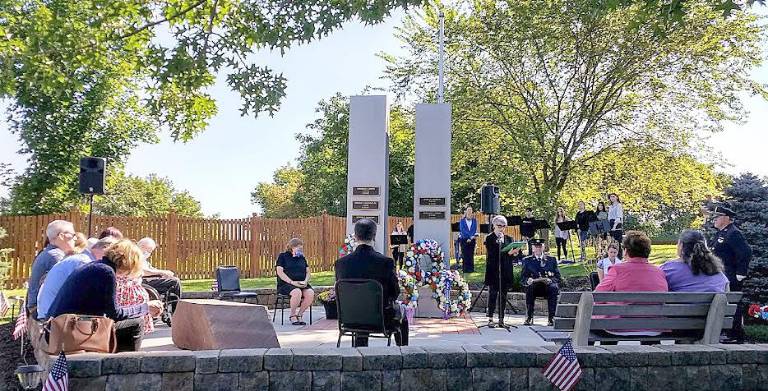 Lynn Berenberg speaks, surrounded by members of the clergy as well as by family members of the deceased on this the 20th anniversary of the Sept. 11 terrorist attack on the country.