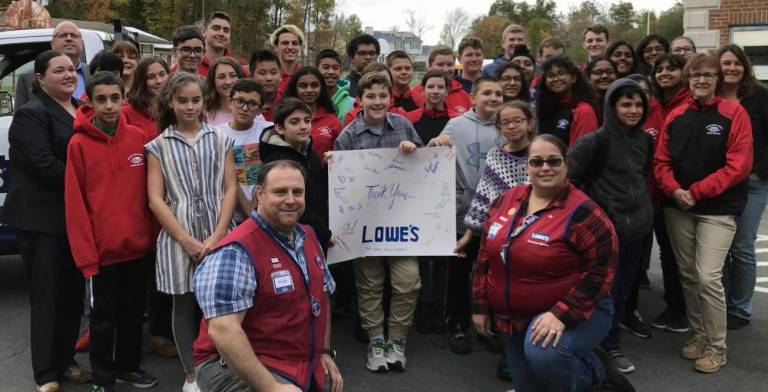 Members of Goshen Science Olympiad senior and junior teams gather 'round Lowe's managers Paul and Victoria to say thank you for delivering $2,500 in merchandise.
