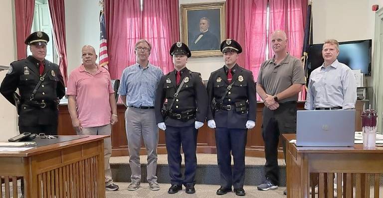 Sgt. Gregory A. Kelemen and Det. Robert A. Kozlowski are congratulated by the Goshen Village Board during promotion ceremonies on June 28. Left to right are: Chief James C. Watt, Mayor Peter Smith, Trustee Christopher Gurda, Detective Kozlowski, Sgt. Kelemen, Trustee Daniel Henderson and Deputy Mayor Scott Wohl. Photos provided by the Village of Goshen Police Department.