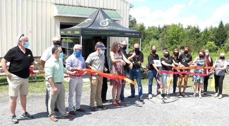 On Wednesday, Aug. 12, New York State Senator Jen Metzger,Town of Warwick Supervisor Michael Sweeton and members of the Orange County and Warwick Valley Chambers of Commerce joined co-founders Adam Kurtz and Ed McCauley (center) to celebrate the official grand opening of the Fusion CBD Market, located Route 94 S in the Town of Warwick. Photo by Roger Gavan.