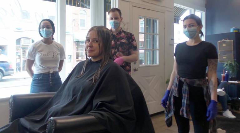 Indigo Beauty Lounge was serving customers by appointment only on Friday while wearing masks. The governor signed an executive order on Friday closing barbershops, hair salons, tattoo or piercing salons, nail salons, hair removal services and related personal care services effective 8 p.m. on Saturday, March 21. Pictured (from left) are Nicole Pena, Robert Mahling, and Ashley Lenahan. A client is seated.