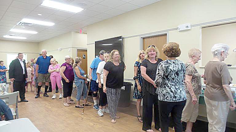 Guests line up for refreshments on opening day of the new senior center in July 2018