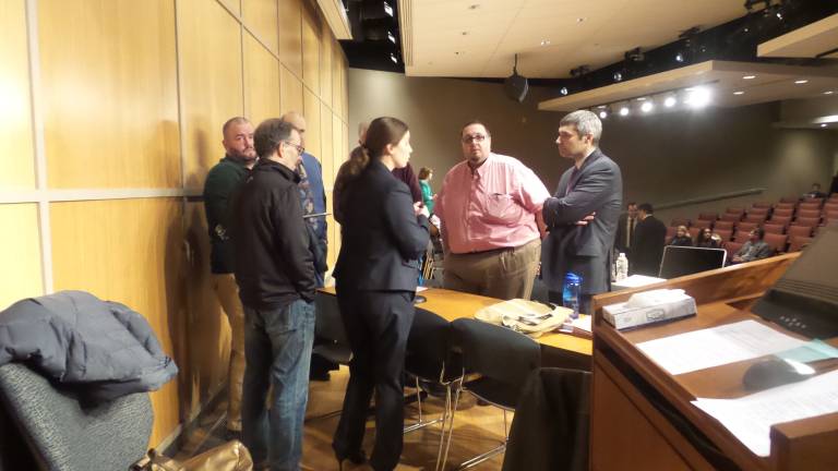 Longtime planning board member says Legoland supporters removed him Town of Goshen Planning Board members are in a huddle prior to their meeting held at Orange County 911 Center in Goshen on Jan. 5. (Photo by Frances Ruth Harris)