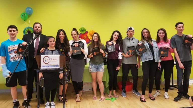 Fidget spinners and fiesta a treat for 'moving up' class at Hebrew school Torah Teens: Chabad awarded local teens who volunteered weekly at Chabad Hebrew School (from left): Gavin Reich of Highland Mills, (Rabbi Pesach), Rosie Schwartz of Monroe, Chana Burston, Sabina Pashkin of Highland Mills, Shaina Steir of Monroe, Emma Favia of Highland Mills, Brenden Ingber of Goshen, Madison Stock of Highland Mills, Dylan Goldstein of Cornwall and Ryan Pearlman of Washingtonville. Not pictured: Devorah Greenwald and Sophie Jaeger of Monroe, Jimmie Murphy of New Windsor (Photo provided)